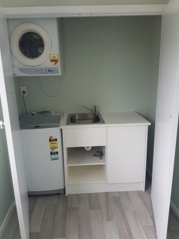 Focal looking into Bettina Rd Laundry with washing machine, dryer and new sink and bench