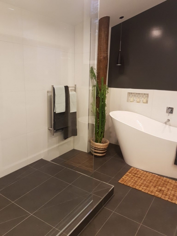 Focal of the new bath and shower in the upstairs bathroom and the existing wooden pole that is a feature at Dudley Ave